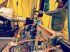 Lab setup of fiber cables with Nabil Shaikh standing in background