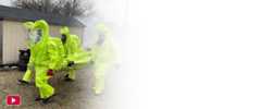People training in HAZMAT suits with the YouTube logo in the bottom left corner of the photo