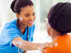 doctor putting hand on the shoulder of an older patient