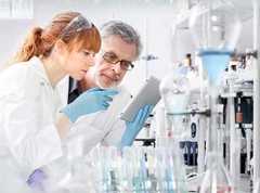 two scientists reviewing information together