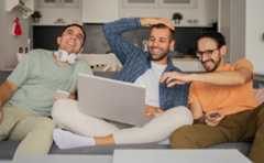 A group of friends streaming a movie and laughing whose data will be collected via Nielsen's streaming measurement solution.