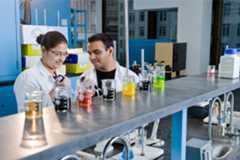 Two students in a chemistry lab working