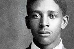 A portrait of  Claude Devoyd Hall as a young man wearing a suit and bowtie