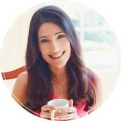 Jenn Segal smiling while holding a mug.