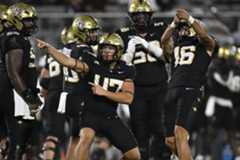 TOS-L-ucf-football-018.jpg UCF kicker Noe Ruelas (16) celebrates his game-winning field goal with long snapper Dalton Riggs (47) during the second half against Oklahoma State, Saturday, Nov. 22, 2025, in Orlando, Fla. (Phelan M. Ebenhack/Special to the Sentinel)