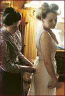 Photograph of Mrs Morrison helping Lady Oliff-Cooper with her dress