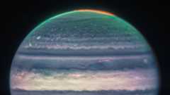 The top half of Jupiter in blue and green against a night sky
