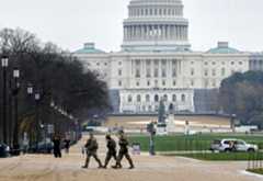 National Guard patrol on the National Mall near the U.S. Capitol, Wednesday, Nov. 26, 2025, in Washington. (AP Photo/Rahmat Gul)