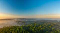 Aerial view of Southeastern Texas in a fog inversion with Autumn colored trees and a deep blue sky.