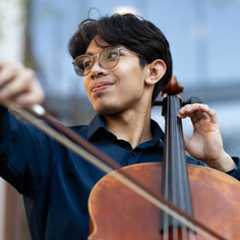 Three University of Rochester sophomores posed together while wearing University of Rochester hats. 