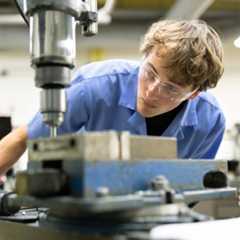 Two University of Rochester students working on an experiment in a lab.