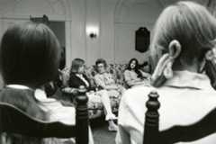 A group of women seated in chairs, engaged in discussion, with Loretta Ford, former School of Nursing dean, present.