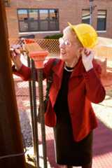 A woman in a hard hat, Loretta C. Ford, signs a steel beam at the Loretta C. Ford Education Wing event, Reunion Weekend 2005.