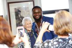 A man captures a moment with Loretta Ford, the former dean of the School of Nursing, showcasing their shared experience.