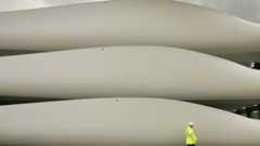 A worker walks past stored wind turbine blades at the Harland & Wolff shipyard in Belfast in 2008. Photo: Peter Macdiarmid/Getty Images