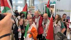 A group of Irish citizens arrive home at Dublin Airport after being held by Israel