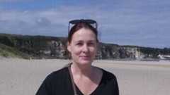 writer Angela Finn (on a beach), a finalist in the 2025 RTÉ Short Story Competition