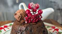 A Christmas pudding topped with red berries