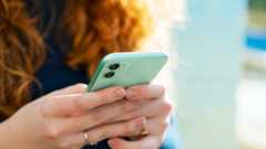 Woman with red hair holding a mobile phone