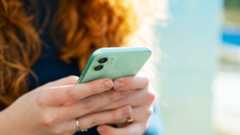 Woman with red hair holding a mobile phone
