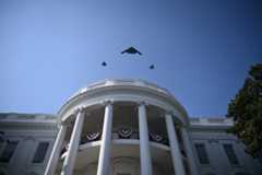 A B-2 Spirit stealth bomber escorted by 2 F-35 Lightning II stealth fighters fly over the White House as US president Donald Trump and First Lady Melania Trump participate in the Military Family Picnic on the South Lawn of the White House. ( (Photo by Brendan Smialowski/Getty Images)