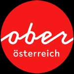 Logo Oberösterreich Tourismus: roter Kreis mit weißem upperaustria Schriftzug