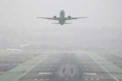 SUT-L-dec-fog-004 An Alaska Airlines jet takes off from San Diego International Airport to the east on a foggy Sunday morning. (K.C. Alfred / The San Diego Union-Tribune)