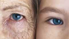 Girl and grandmother, cheek to cheek, close-up, partial view