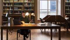 man doing research in a library