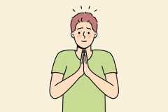Shy man praying with hands together and calm expression, showing a fawning response.