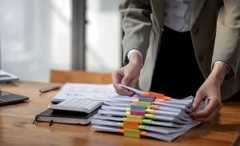 Close-up of someone organising their colour-coded files on a desk.