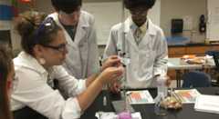 Teacher and kids with science experiment