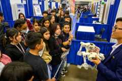 An finalist presenting his research to younger students at Education Outreach Day at Regeneron ISEF, in 2023.