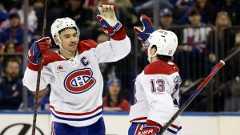 Montreal Canadiens center Nick Suzuki high-fives Cole Caufield (13) after a goal by Caufield in the third period of an NHL hockey game against the New York Rangers Saturday, Nov. 30, 2024, in New York. The Rangers won 4-3. (Adam Hunger/AP)