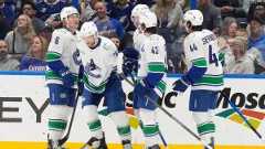 Vancouver Canucks left wing Jake Debrusk (74) celebrates his goal against the Tampa Bay Lightning with right wing Brock Boeser (6), center Elias Pettersson (40), defenseman Quinn Hughes (43), and left wing Kiefer Sherwood (44) during the second period of an NHL hockey game Sunday, Nov. 16, 2025, in Tampa, Fla. (Chris O'Meara/AP)