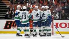 Vancouver Canucks players celebrate a goal by centre Max Sasson (63) during the third period of an NHL hockey game against the Anaheim Ducks, Wednesday, Nov. 26, 2025, in Anaheim, Calif. (Kyusung Gong/AP)