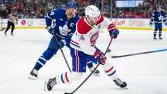 Montreal Canadiens' Nick Suzuki (14) shoots the puck as Toronto Maple Leafs' Auston Matthews (34) looks on during third period NHL action in Toronto on Saturday, April 12, 2025. (Arlyn McAdorey/CP)