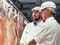 Meat inspectors at a freezing works