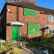 A boarded up house in Bolton