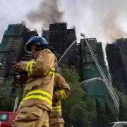 Firefighters are working to extinguish the fire (Chan Long Hei/AP)