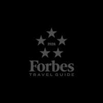 Forbes Travel Guide 2026 logo with five stars arranged in a circle above the text Forbes Travel Guide.