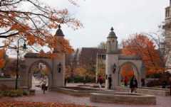 Students pass through the Sample Gates at Indiana University in Bloomington.