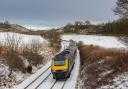 A file image of a ScotRail train travelling in snowy conditions