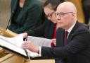 First Minister John Swinney pictured in the Scottish Parliament