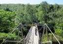 Visitors enjoy the view down Corrieshalloch Gorge from the now-closed suspension bridge