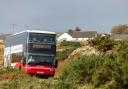 A bus is seen driving from Fionnphort to Craignure on the Isle of Mull (Unsplash)