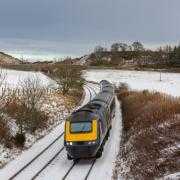 A file image of a ScotRail train travelling in snowy conditions