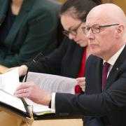 First Minister John Swinney pictured in the Scottish Parliament