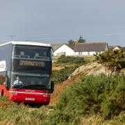 A bus is seen driving from Fionnphort to Craignure on the Isle of Mull (Unsplash)