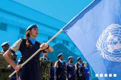woman raises the UN flag